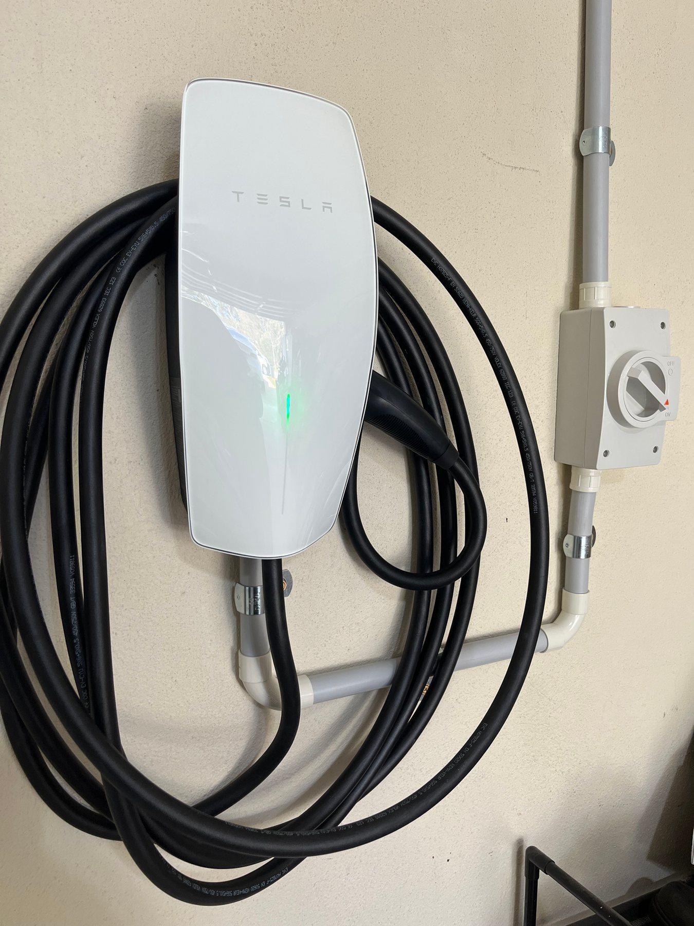 Tesla wall connector EV charger installed in a garage