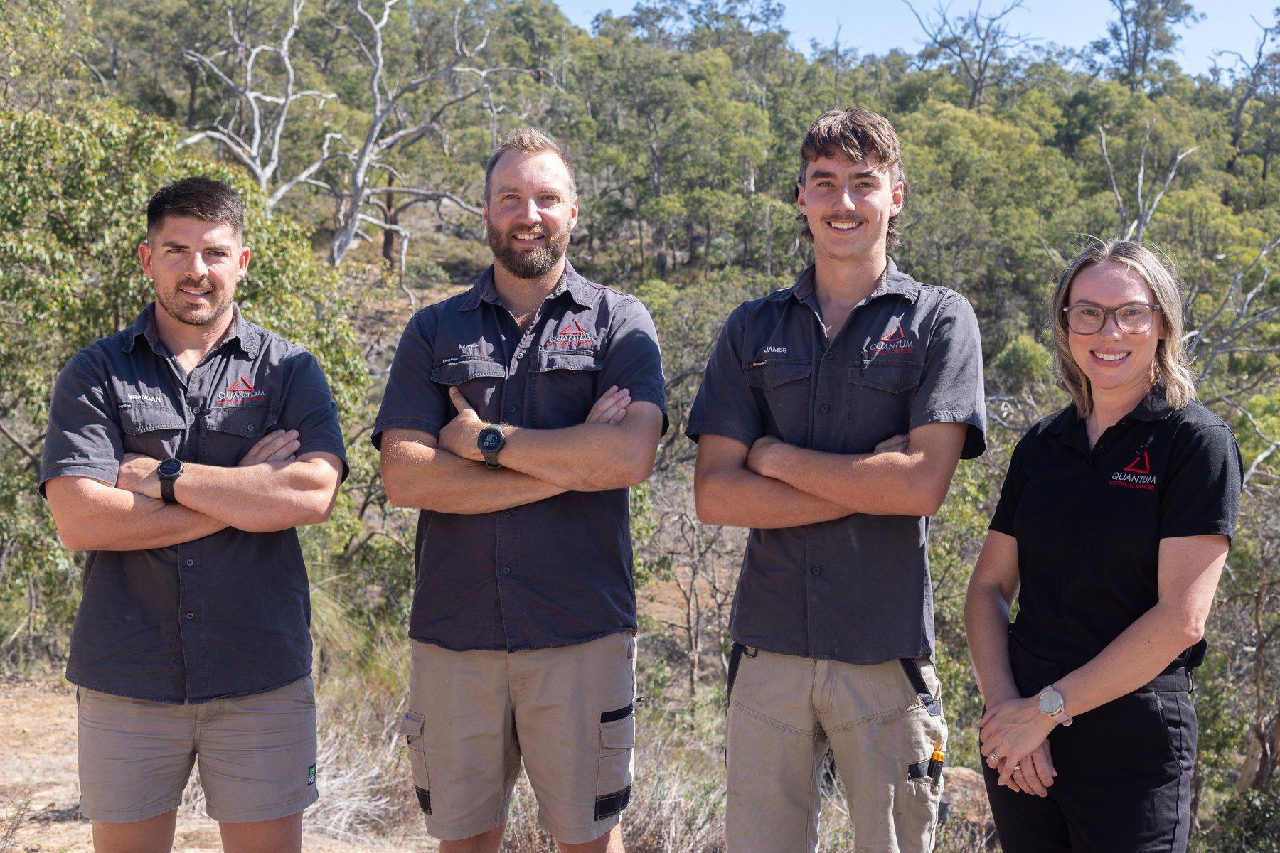 Quantum Electrical team members standing together in Perth Hills bushland