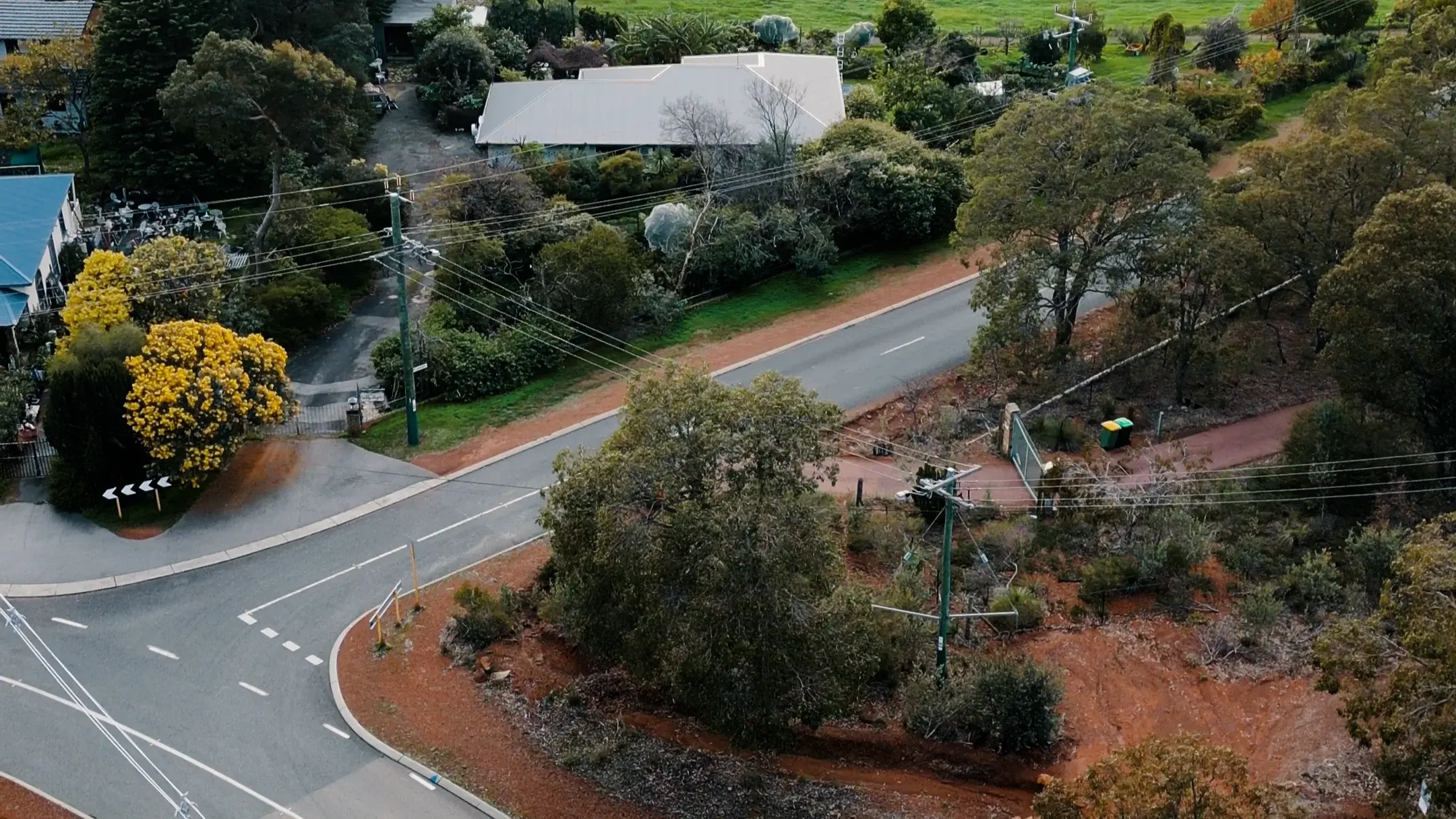 Aerial view of a Quantum van parked on a tree-lined Perth Hills driveway